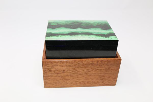 A grossular green garnet mineral box 4cm high by 12.5cm wide, 645g