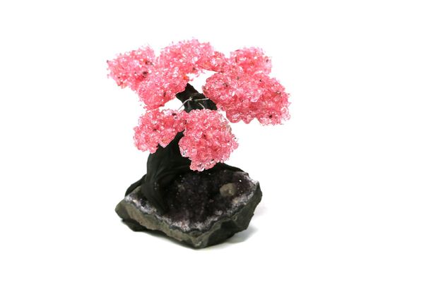 A rose quartz tree with nine petals on amethyst and composition base 14cm high