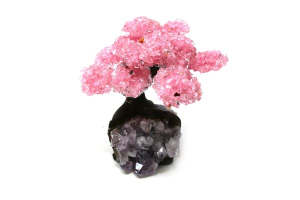 A rose quartz tree with fifteen petals on amethyst and composition base 18cm high