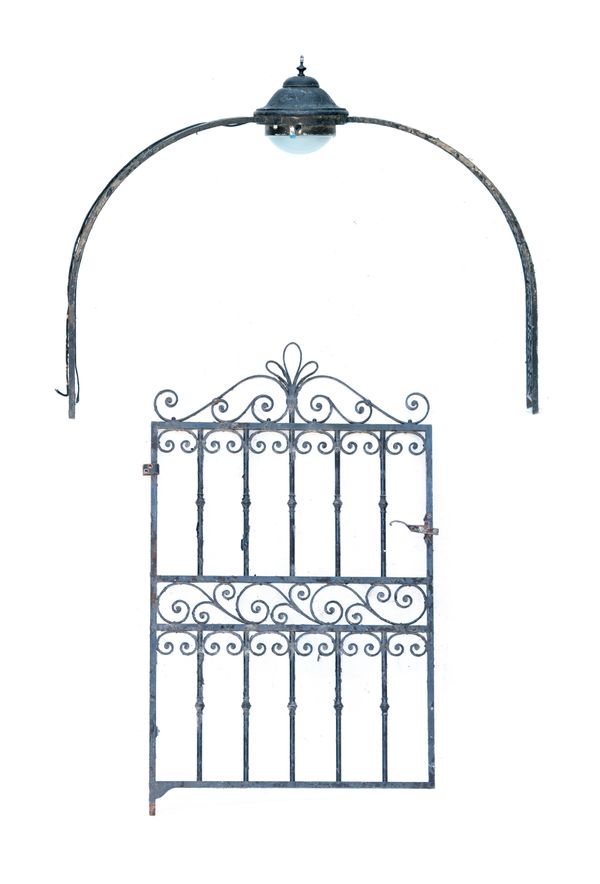 A wrought iron overthrow with central light together with a pedestrian gate  early 20th century the overthrow 130cm high by 160cm wide, gate 163cm...