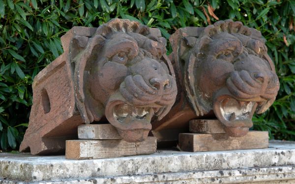 A pair of glazed architectural lions head corbels, possibly Scottish late 19th century 48cm high by 50cm wide
