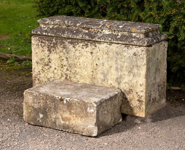 A carved stone base now adapted as a mounting block 52cm high by 82cm long