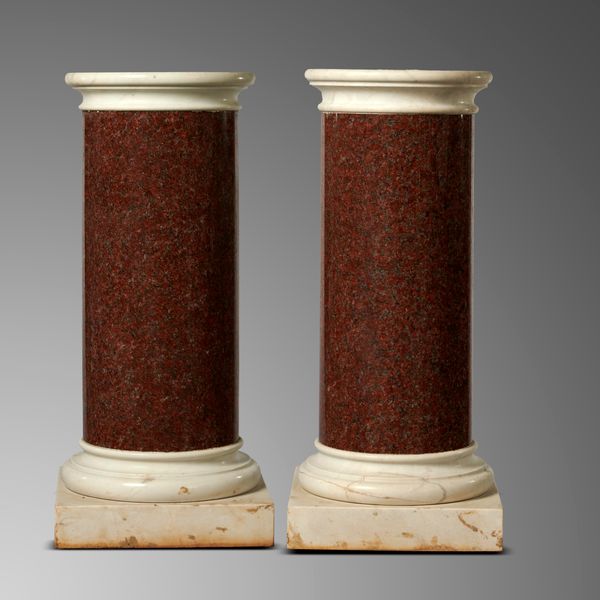 A pair of red granite column pedestals 19th century  with white marble caps and bases 112cm high by 46cm diameter (top)