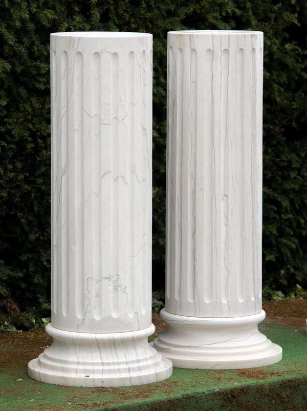 A pair of veined white marble column pedestals modern one base damaged 117cm high  