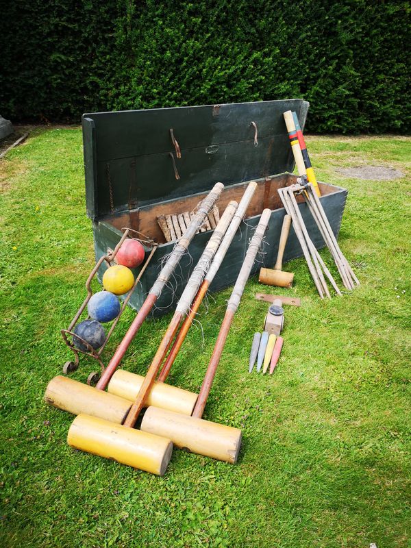 A Jacques and Sons croquet set early 20th century  with mallet, balls, iron hoops with ground sleeves, iron hoop gauge, marker posts and other...