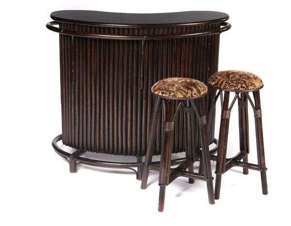 An ebonised wood Tiki bar together with two stools 130cm wide The history of the Tiki Bar can be traced back to 1934 when Texas born Earnest Raymond...