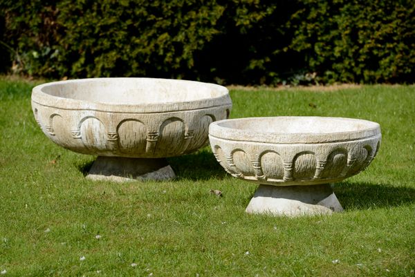 Two composition stone planters 20th century on associated bases the larger 91cm diameter