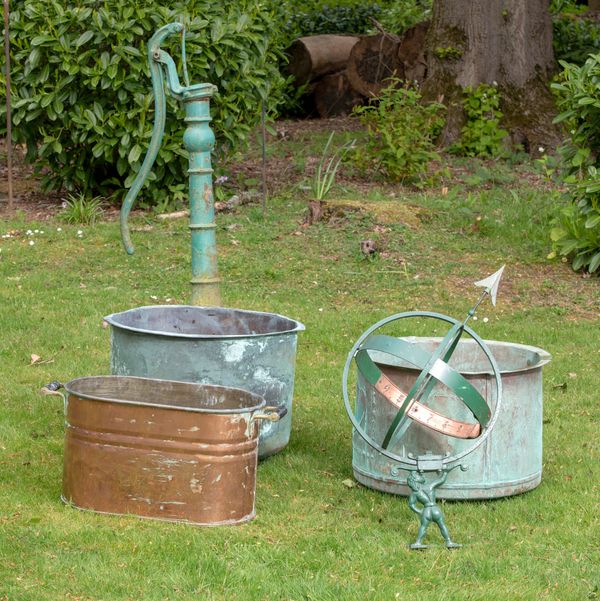 Two riveted washing coppers 19th century the larger 63cm diameter, an iron and copper armillary sphere, 63cm high, a cast iron pump and a copper...