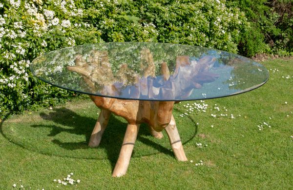 A rootwood table with glass top  180cm diameter