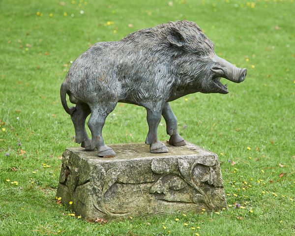 A bronze boar 20th century on associated composition stone base 87cm high by 80cm wide