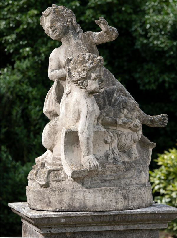 A composition stone group of two playing putti 2nd half 20th century  125cm high