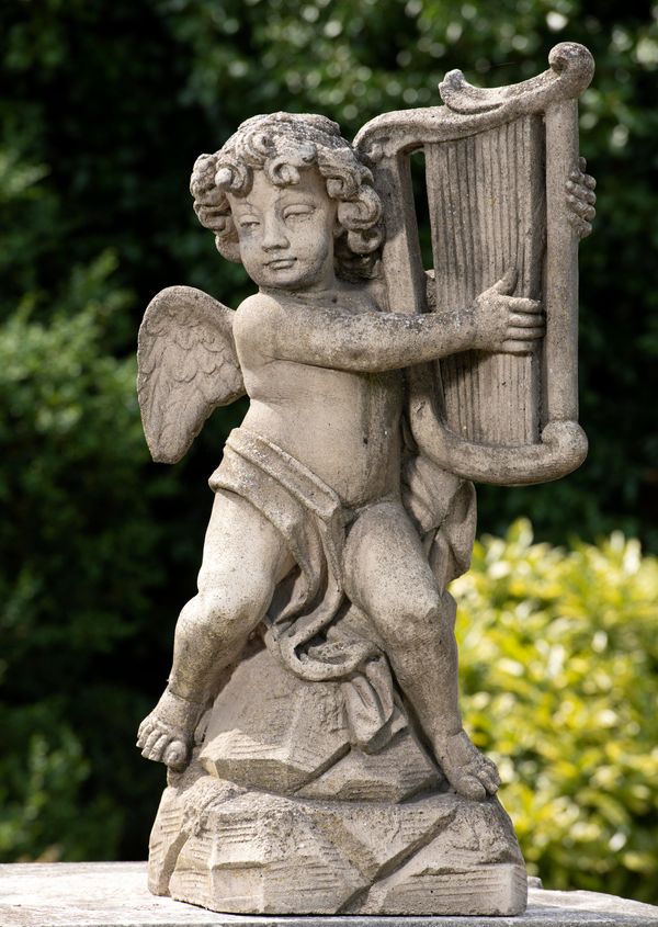 A composition stone figure of a cherub playing a harp 2nd half 20th century 100cm high