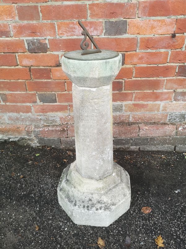 A carved Edwardian limestone sundial early 20th entury with 8in bronze dial 80cm high