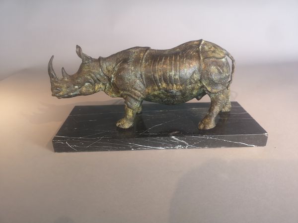 A bronze rhinoceros modern on marble base 19cm high by 38cm long