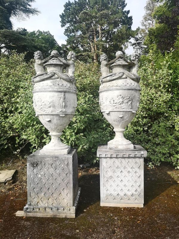 A pair of substantial composition stone lidded urns on pedestals late 20th century 230cm high