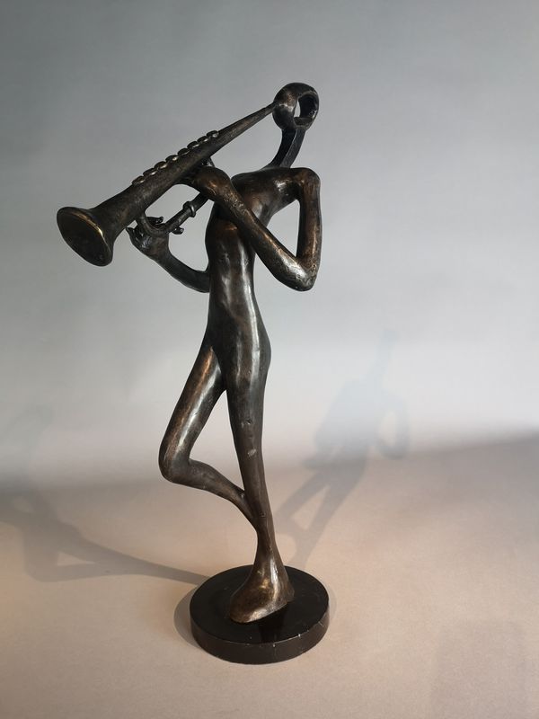 A bronze stylised figure playing a musical instrument modern on marble base 63cm high