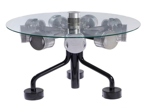 A circular topped table incorporating 1930‘s aircraft pistons 80cm high by 102cm diameter 