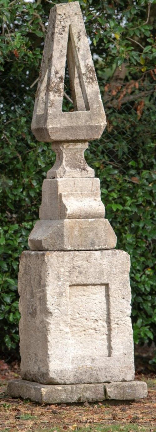 An unusual carved stone finial on associated base mid 19th century 250cm high