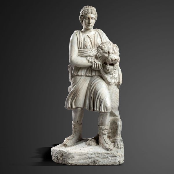 A plaster classical figure standing next to a seated lion 2nd half 20th century 96cm high