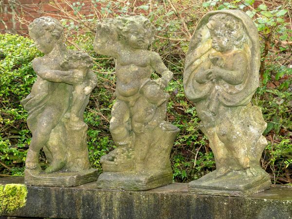 A set of three composition stone putti representing Spring, Autumn and Winter 84cm high