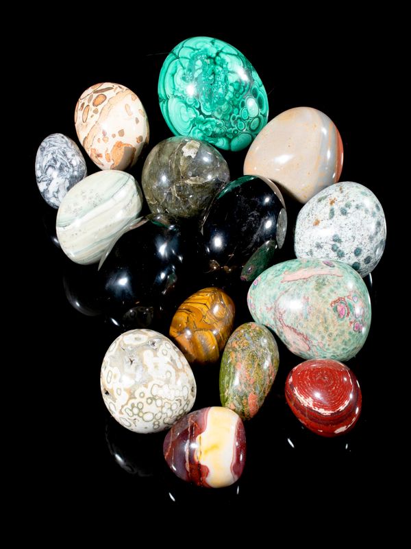 Fourteen mineral eggs consisting of malachite, obsidian, anthracite, ruby in fuchsite, ocean jasper, pinolite, red jasper, mookite, unikite,...
