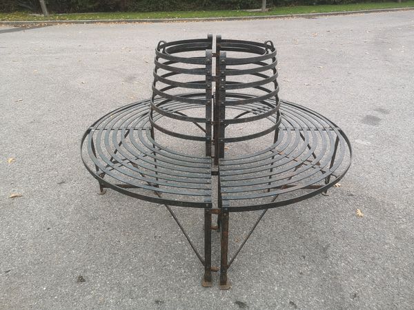 A wrought iron tree seat 2nd half 19th century in two halves 170cm diameter