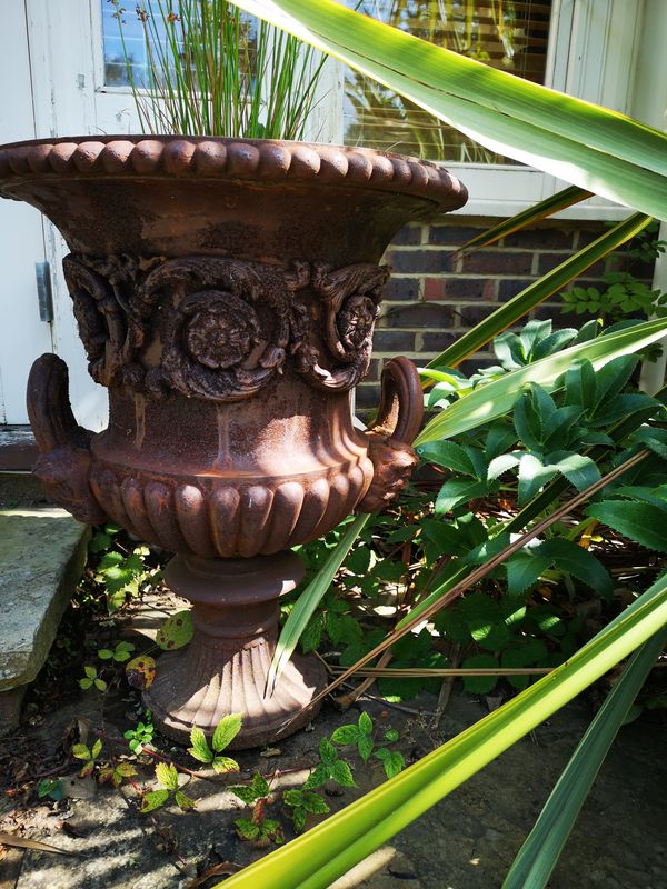 A pair of Handyside Foundry cast iron urns