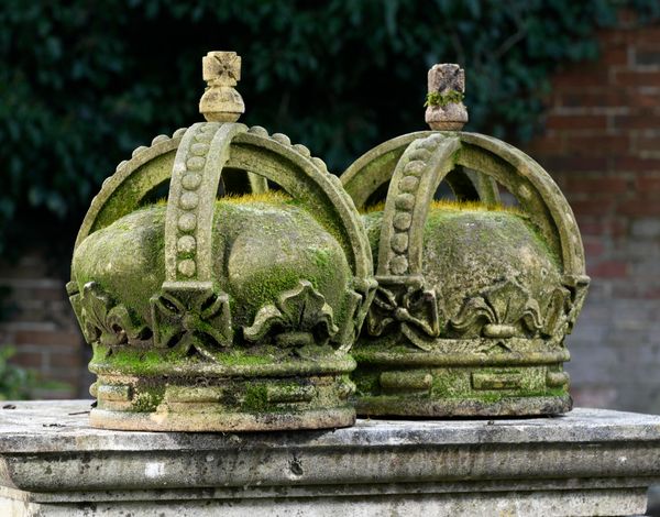 † A pair of carved sandstone crowns modern 42cm high 