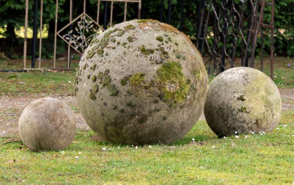 † A set of three carved sandstone balls modern the largest 70cm diameter, 43cm diameter and 28cm diameter