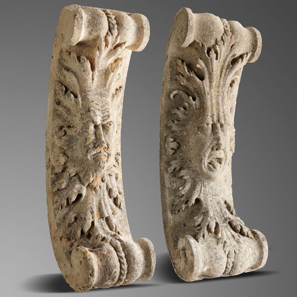 A pair of rare Georgian Portland stone architectural brackets circa 1740  carved in high relief with green man masks 84cm high