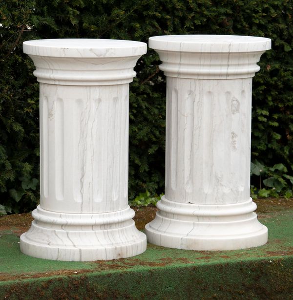A pair of carved white veined marble pedestals  modern 117cm high  