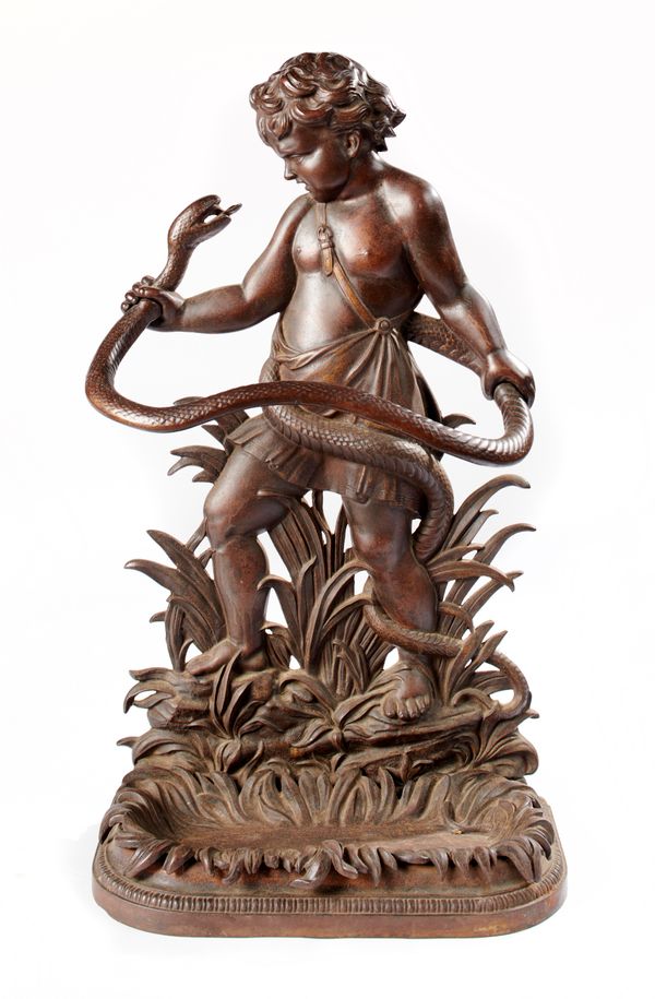 A Victorian cast iron stick stand in the form of the infant Hercules wrestling with a snake 2nd half 19th century  the lift out drip tray with...