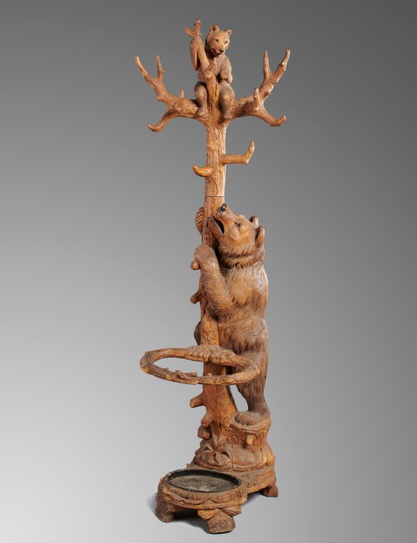 A carved walnut Black Forest stick stand Bavarian, 2nd half 19th century 204cm high  Black Forest carvings are often humorous and whimsical - bears...