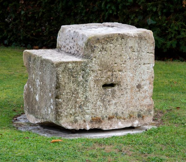 A carved limestone mounting block 50cm high by 45cm wide