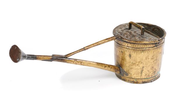 An unusual brass watering can possibly late 18th century with embossed decoration and associated rose. 83cm long This lot and lots 257 to 259 and...