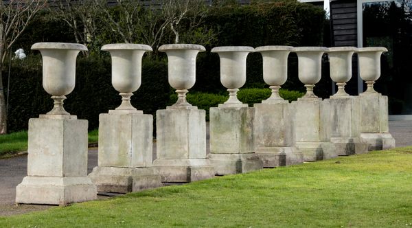 ‡ A set of four composition urns on pedestals late 20th century 158cm high 