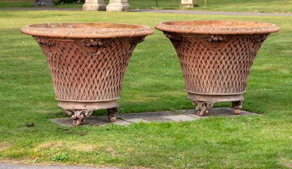 A pair of composition basket planters 2nd half 20th century 80cm high by 110cm diameter