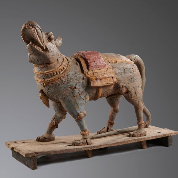An unusual polychrome painted wood Vihana Indian, late 19th century  in the form of a mythical creature on integral wooden base 114cm high by 144cm...