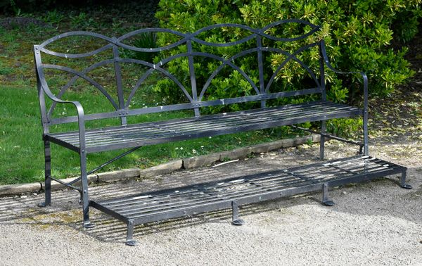‡ A Regency style wrought iron games seat 2nd half 20th century with hinged foot rest 207cm wide 