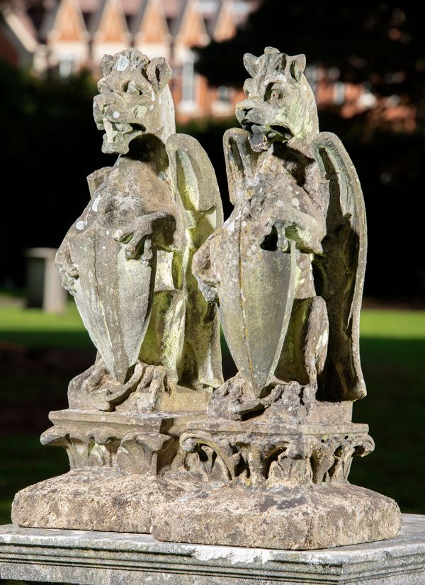 A pair of carved sandstone griffins circa 1870 on later composition stone base 80cm high