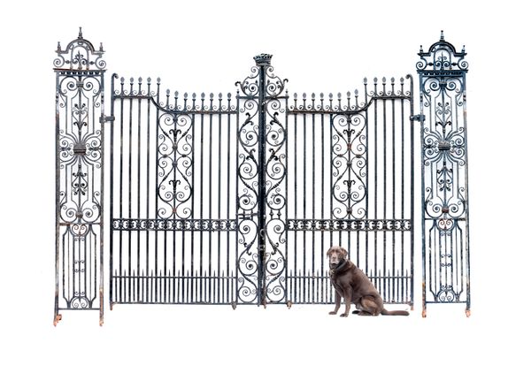 An impressive pair of Georgian style wrought iron gates last quarter 19th century the gates surmounted by an earl‘s coronet flanked by pilasters with...