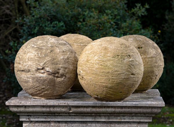 A set of four composition stone balls modern 36cm diameter