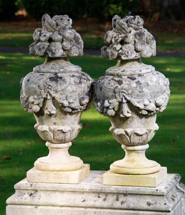 A pair of composition stone finials  late 19th century on later bases 80cm high