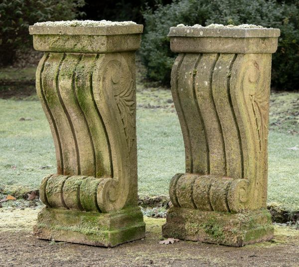 † A pair of carved sandstone wall consoles carved with scrolls modern 92cm high