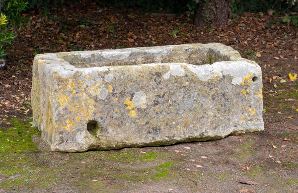 A rectangular carved limestone trough 50cm high by 136cm long by 70cm deep