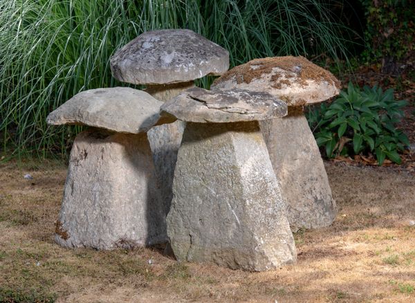 A harlequin set of four carved Cotswold stone staddlestones the largest 84cm high  Unsold lot fee to collect GE082