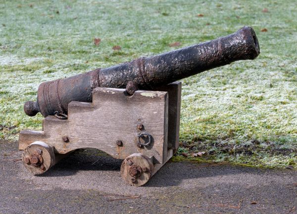 A small cast iron cannon 19th century on later wooden carriage barrel 87cm long