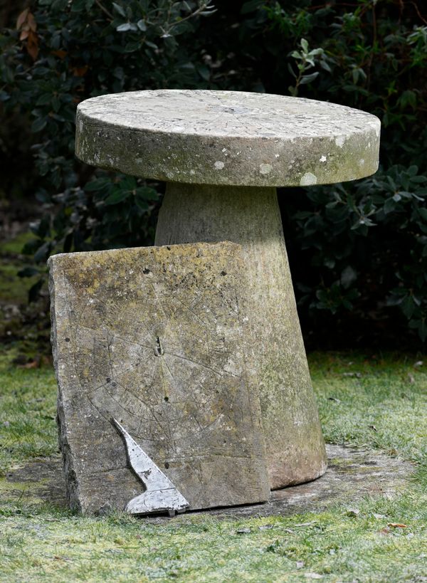 A carved stone wall sundial 19th century with later bronze gnomon 49cm by 38cm, together with a circular wall sundial, lacking gnomon made up from a...