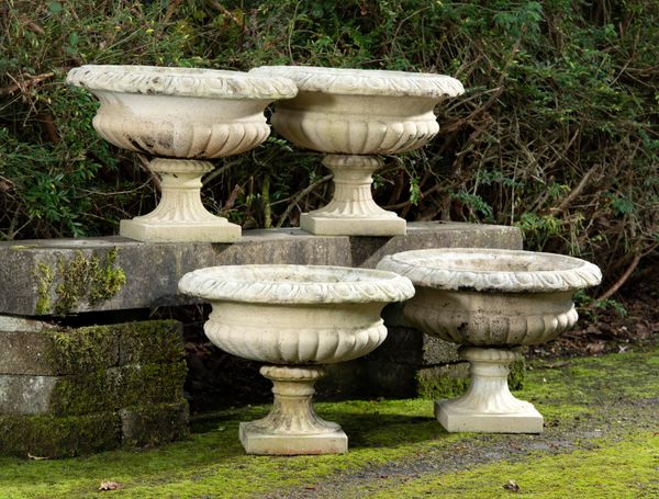 A similar set of four composition stone urns