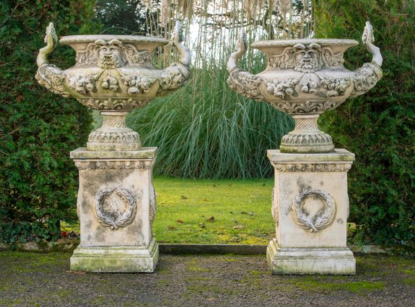 A pair of composition stone urns on pedestals late 20th century 127cm high